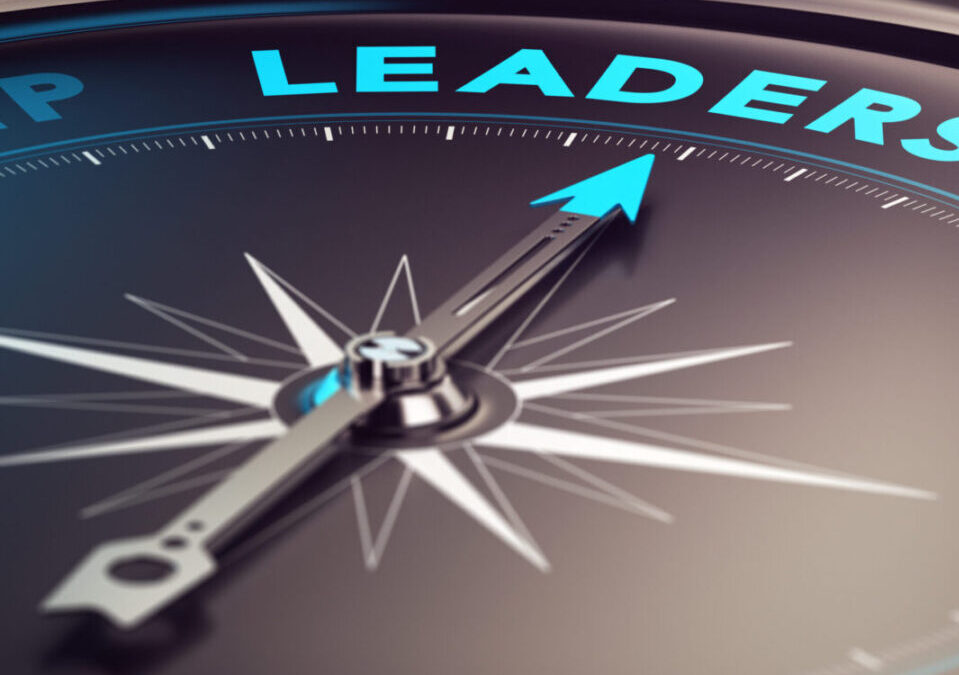 Compass with needle pointing the word leadership with blur effect plus blue and black tones. Conceptual image for illustration of leader motivation