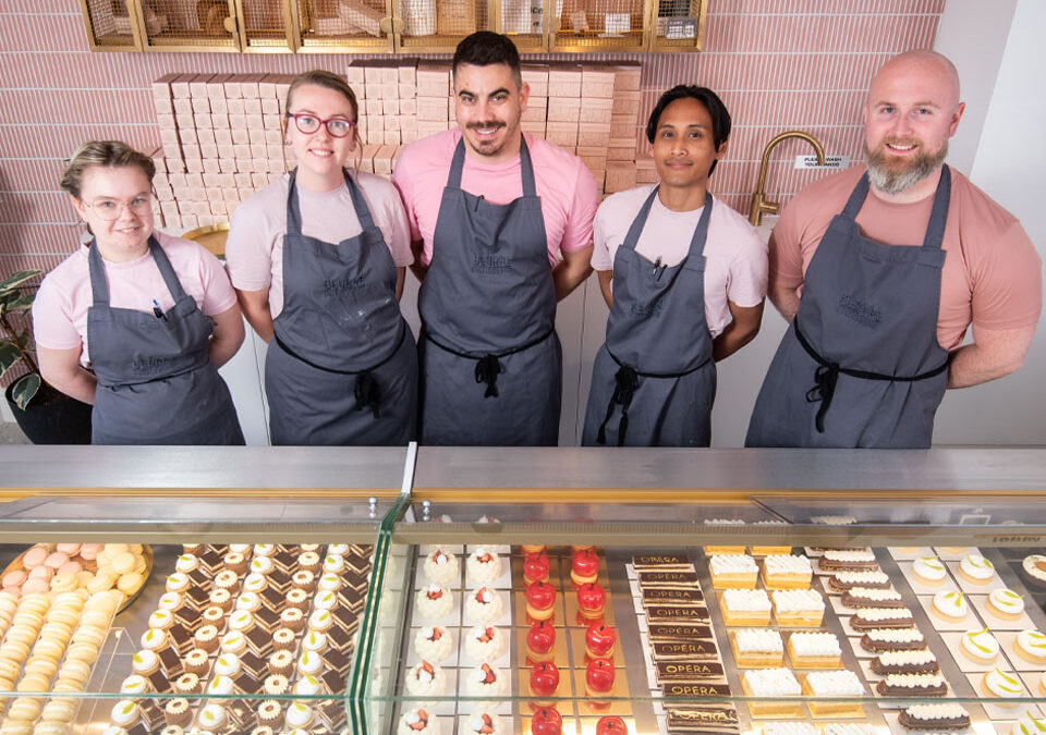 Full staff, overhead shot showing cakes. Beurre Patisserie in St Annes