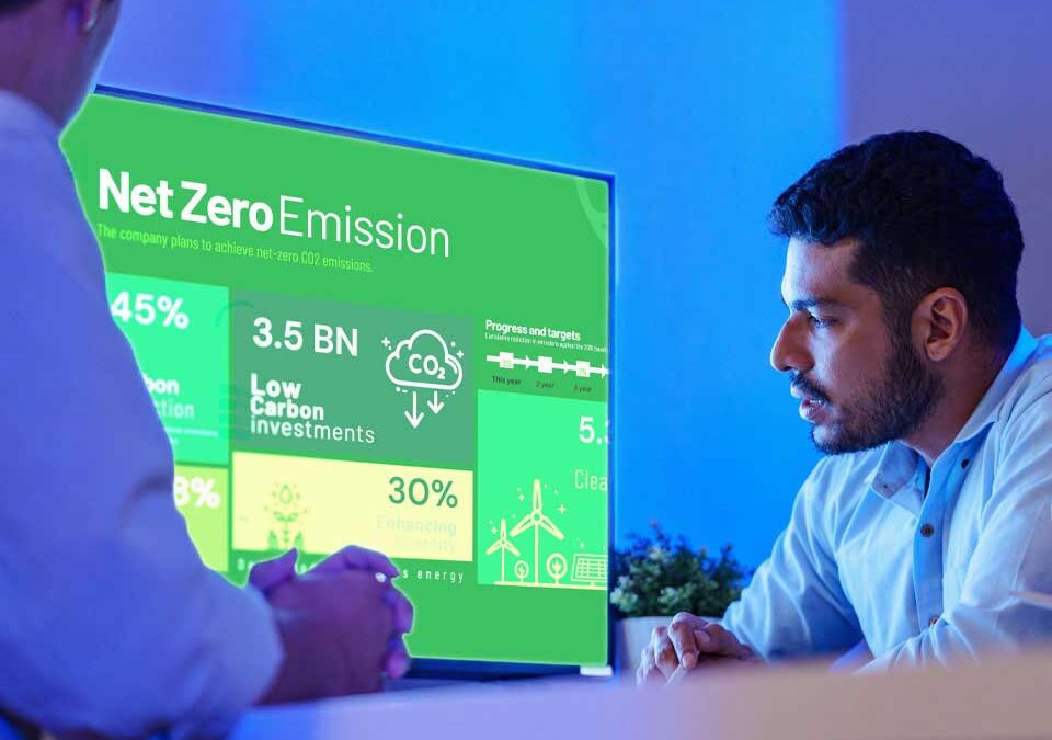 Two people looking at a computer screen with net emissions graphs