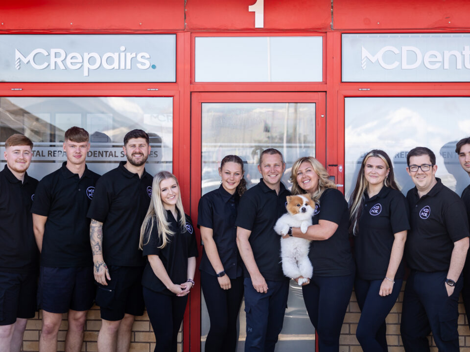 Full team of MC Repairs stood outside shop