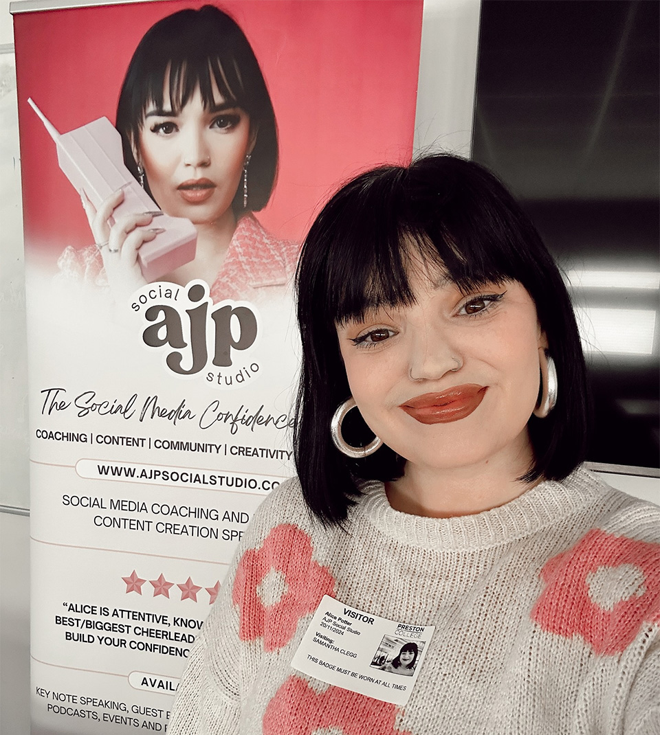 Alice Potter standing in front of a banner for AJP Social Studio