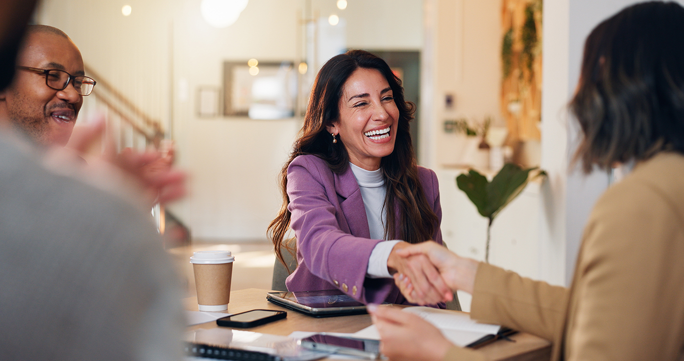 Happy, business people or meeting with handshake for promotion, hiring or recruiting at office. Group, employees or shaking hands with candidate for job opportunity, deal or partnership at workplace.
