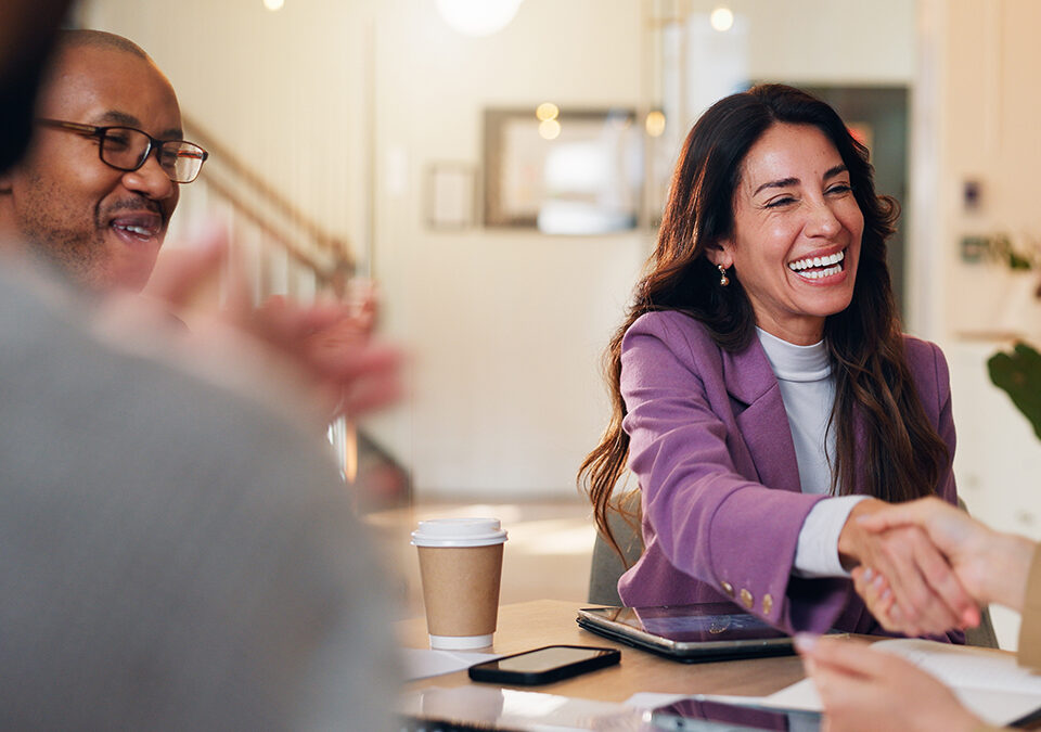 Happy, business people or meeting with handshake for promotion, hiring or recruiting at office. Group, employees or shaking hands with candidate for job opportunity, deal or partnership at workplace.