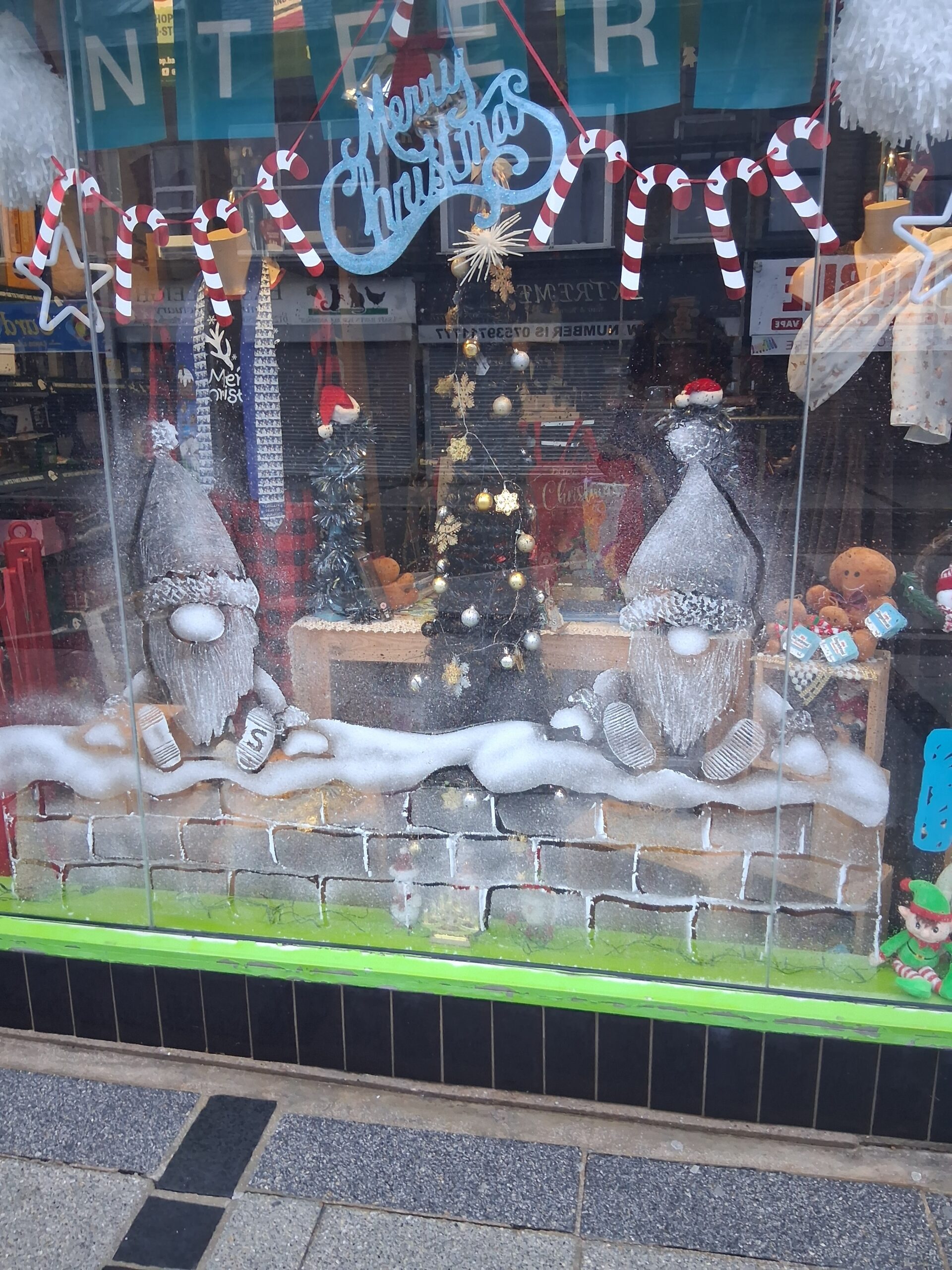 Shop window with a snow sprayed festive scene