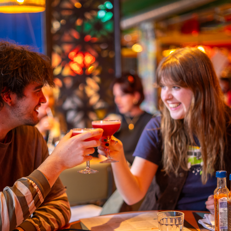 a young couple drinking cocktails